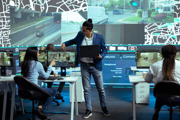 Indian coordinator offers instructions for his staff in control center monitoring room, following...
