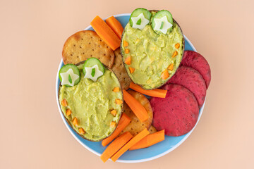 Tasty and healthy snack for kids including avocado cream, vegetable cookies.