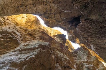 Sunlight filtering through rocky cave ceiling in Southern Turkey