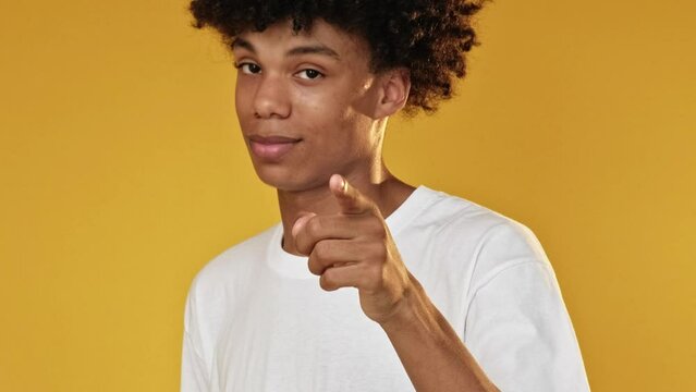 Heart gesture. Love sign. Confident guy flirting blowing air kiss expressing adore romantic affection isolated on yellow free space background.