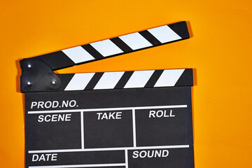 Obraz premium clapper board of video cinema in studio. Movie production clapper board on orange background