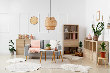 Interior of modern stylish living room with grey sofa and plaid