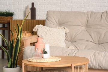 Stylish sofa with coffee table in living room