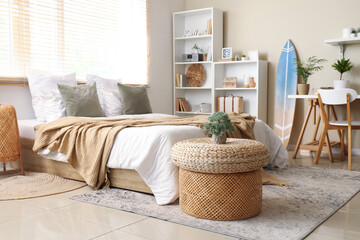 Interior of bedroom with comfortable bed and large window