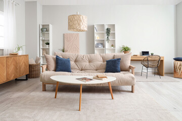 Stylish interior of living room with soft sofa and coffee table