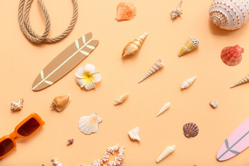 Sunglasses, surfboard and seashells on beige background. Summer concept