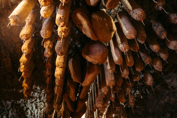 Salami and Prosciutto Hanging from the Ceiling in Kart, Slovenia for an Authentic Culinary Experience