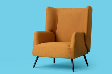 Cozy armchair on blue background