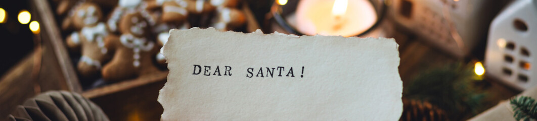 Banner. Christmas letter on craft paper to Santa Claus with text: Dear Santa. Cozy home interior...