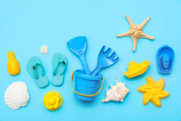 Beach accessories for children and kid's flip-flops on blue background. Top view