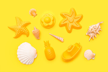 Beach accessories for children on yellow background. Top view