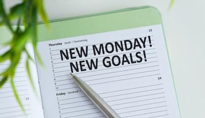 New Monday, New Goals text concept. Spiral notebook textbook, wooden pencil, new Monday, new goals