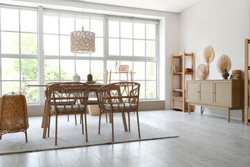 Interior of stylish room with wooden dining table and shelf units