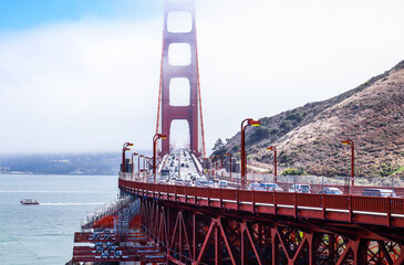 Golden gate bridge with fog and ship in the background, San Francisco. USA. © supatpismai-grazioso