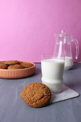 oatmeal multigrain biscuits, a glass of milk on a pink background with space for text. Healthy baby food afternoon snack concept