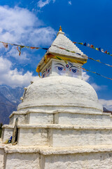 Stupa with Buddha eyes in Nepal. Religious building of buddhism pagoda in the high Himalaya mountains and Kathmandu capital city. Sacred place of Buddhism with prayer flags in beautiful peaceful place