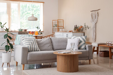Interior of stylish kitchen with grey sofa and table