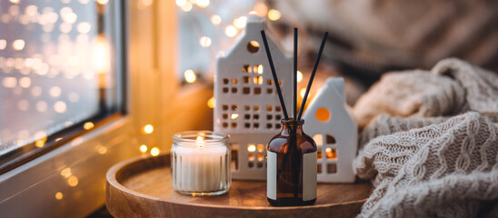 Banner. Christmas home aromatherapy. Cozy atmosphere, holiday spirit. Winter inspiration. Aroma diffuser with pine extract, organic essential oil, vanilla, gingerbread cookies, candles on wooden table