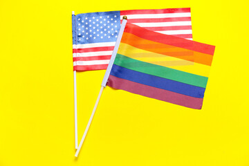Flags of LGBT and USA on yellow background