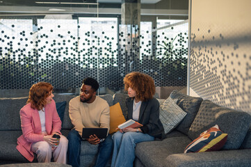 Interracial trendy workers having briefing and collaborating on project
