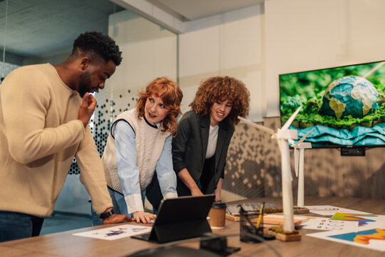 Diverse businesspeople discussing renewable energy sources project. - Powered by Adobe