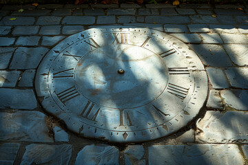 A clock tower with its shadow forming a sundial on the ground. Concept of ancient and modern timekeeping. Generative Ai.