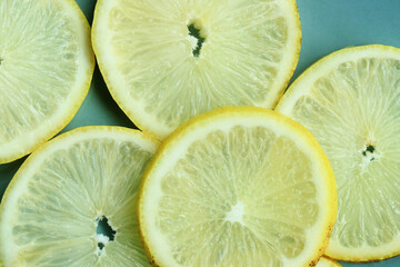 Pile of fresh lemon slices on blue plate