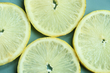 Pile of fresh lemon slices on blue plate