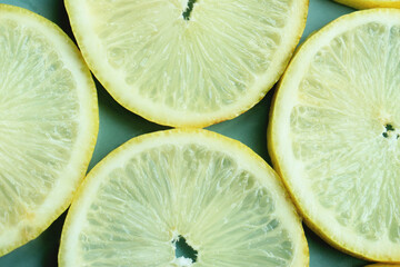 Pile of fresh lemon slices on blue plate