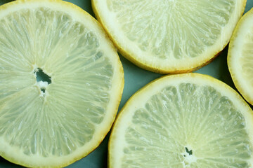 Pile of fresh lemon slices on blue plate