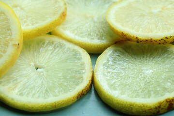 Pile of fresh lemon slices on blue plate