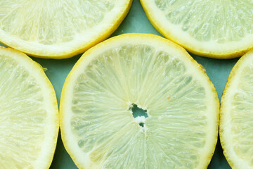 Pile of fresh lemon slices on blue plate