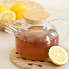 lemon tea in glass teapot isolated on white