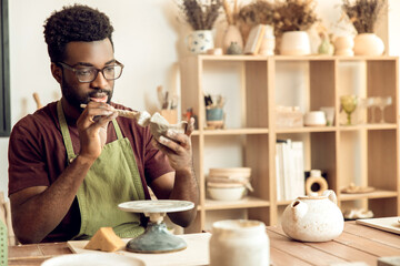 Professional working in a pottery studio on creation of a new product