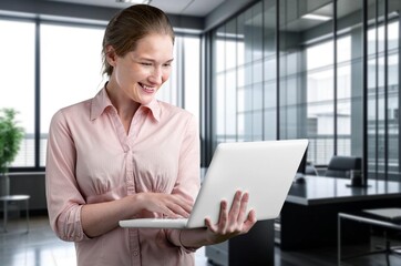 Woman working, checking emails sitting in an office