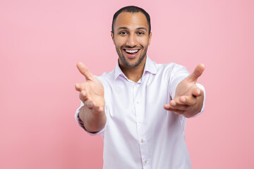 Friendly man in white shirt showing welcome gesture