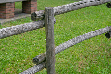 wooden fence, for fencing a park, garden, avenue. Round poles with seasoned wood, usually chestnut, which resists well outdoors