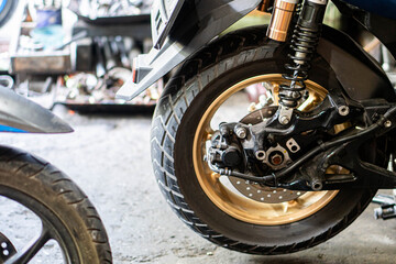 Motorcycle Rear Wheel and Suspension in Workshop