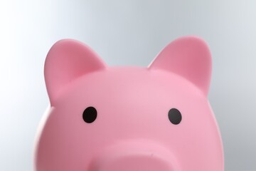 Pink piggy bank on grey background, closeup