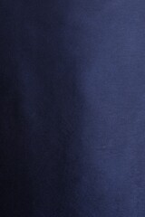 Texture of dark blue silk fabric as background, top view