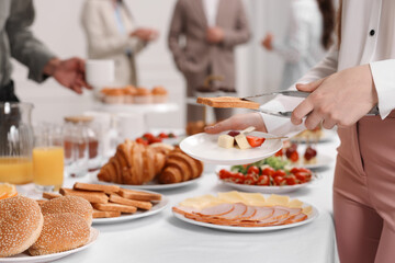 Coworkers having business lunch in restaurant, closeup