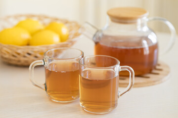 Fresh lemon and lemon tea in wooden dish