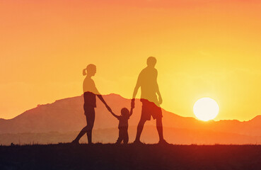 family walking together at sunset