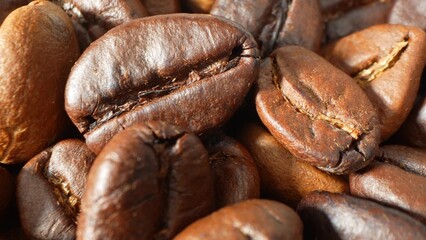 Up close, coffee beans shine with a glossy sheen, a tapestry of rich browns woven with care. The artistry of roasting unveils textures and hues, ensuring each sip bursts with robust flavor.
