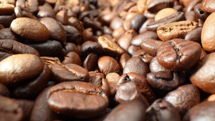 Dark as a moonless night, these coffee beans shimmer with an oily luster, hinting at their robust flavor. Textures interplay, revealing the meticulous roast that elevates each bean to perfection.
