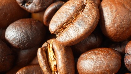 Immersed in a deep, velvety hue, these coffee beans exude a glossy sheen, testimony to their artisanal roasting. Each bean bears intricate cracks, a testament to the meticulous craft behind every cup.