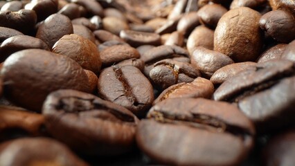 In this close-up, coffee beans shine with a medley of dark hues, their even texture and size hinting at the craftsmanship behind every roast. A testament to the pursuit of perfection in each cup.

