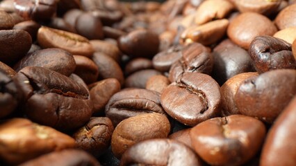 These coffee beans, kissed by the roaster's craft, boast a captivating range of brown hues. Their consistent roast and shimmering oils hint at a medium to dark profile, ready to brew perfection.
