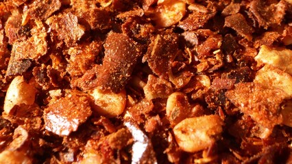 Up close, ground chili teases the eye with its fiery palette, a blend of passionate reds and robust browns. Its texture, a medley of flakes and seeds, promises a tantalizing, spicy experience.
