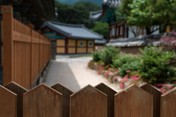 View of the wooden fence on the pathway in the Buddhist temple